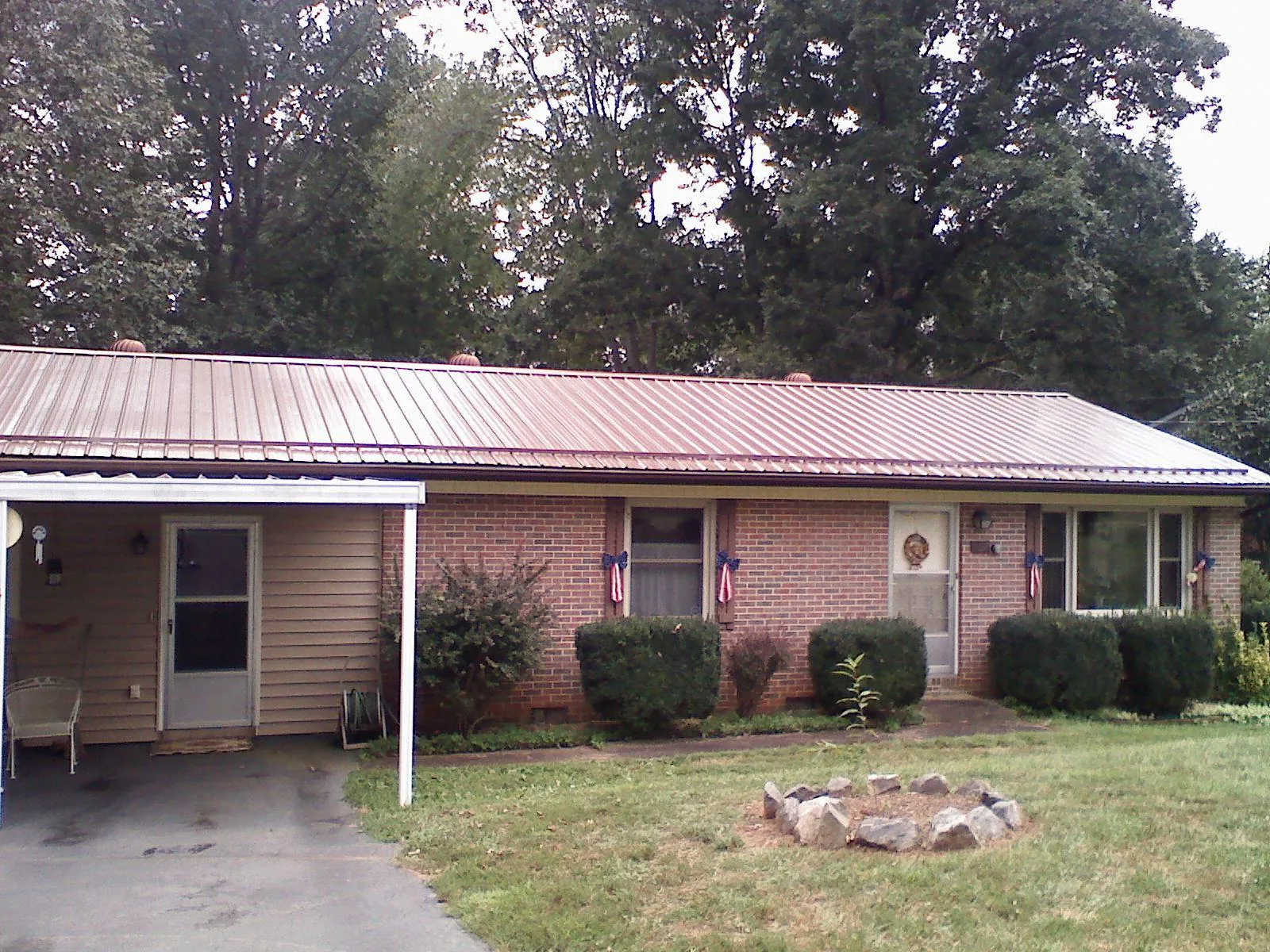 Bronze metal roof and carport on a brick ranch home — Roof Repair work by our crew in East Rutherford