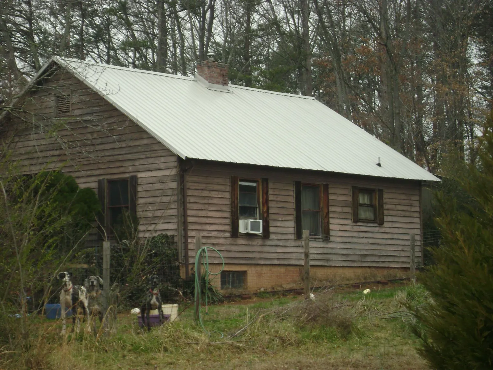 White metal roof on an old wood sided farmhouse, from a Asphalt Shingle Roof Repair job in East Rutherford